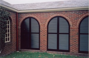 arched shutters block the wind in this breezeway
