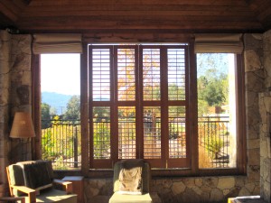 Plantion shutters used to block the sun on the outdoor lobby of this Dude Ranch