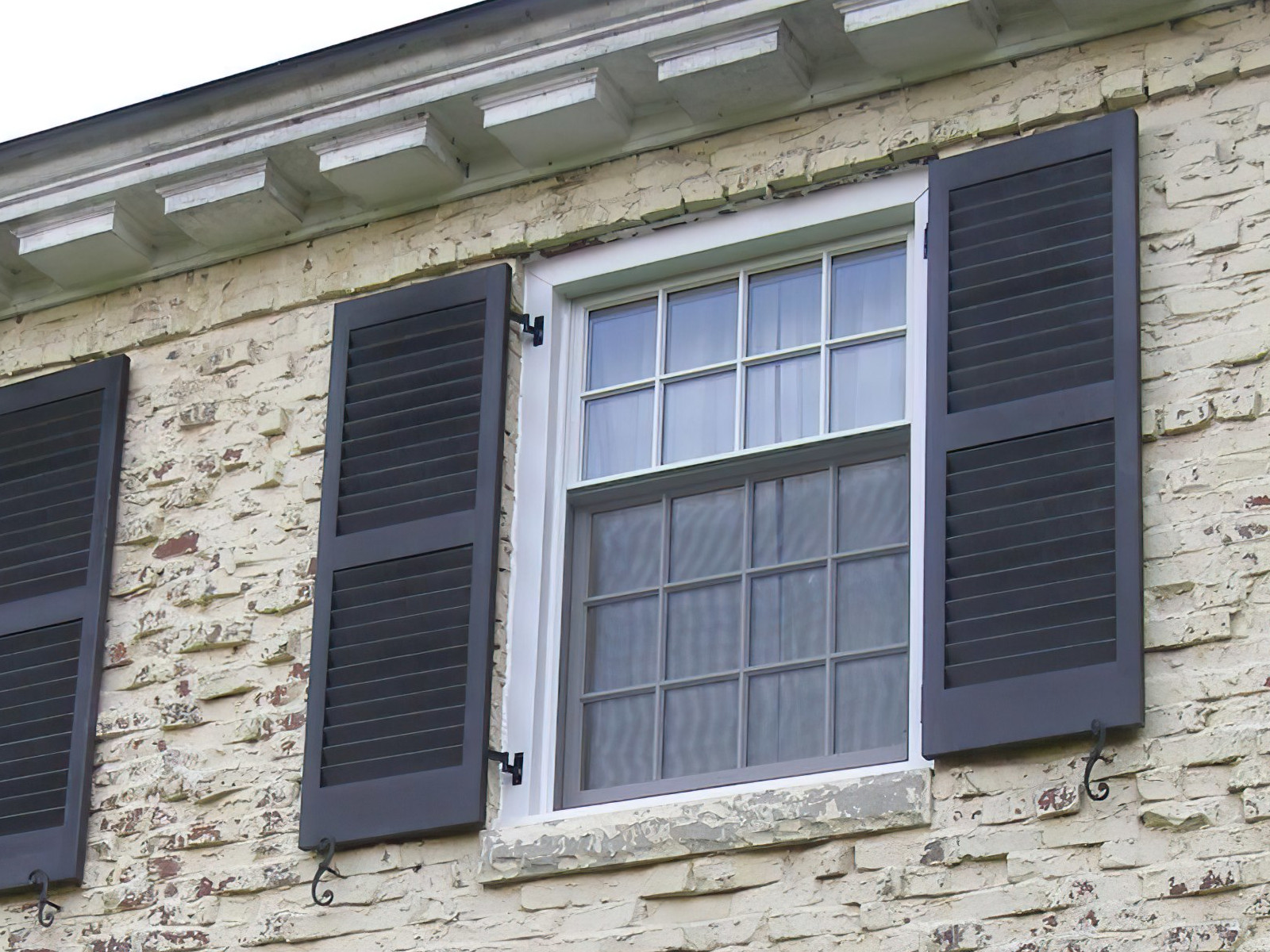 exterior shutter hardware on a stucco home