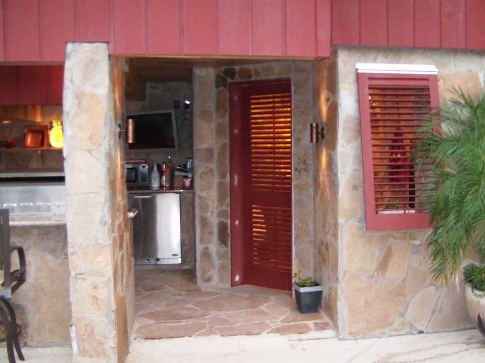 exterior shutters and doors on a coastal outdoor kitchen