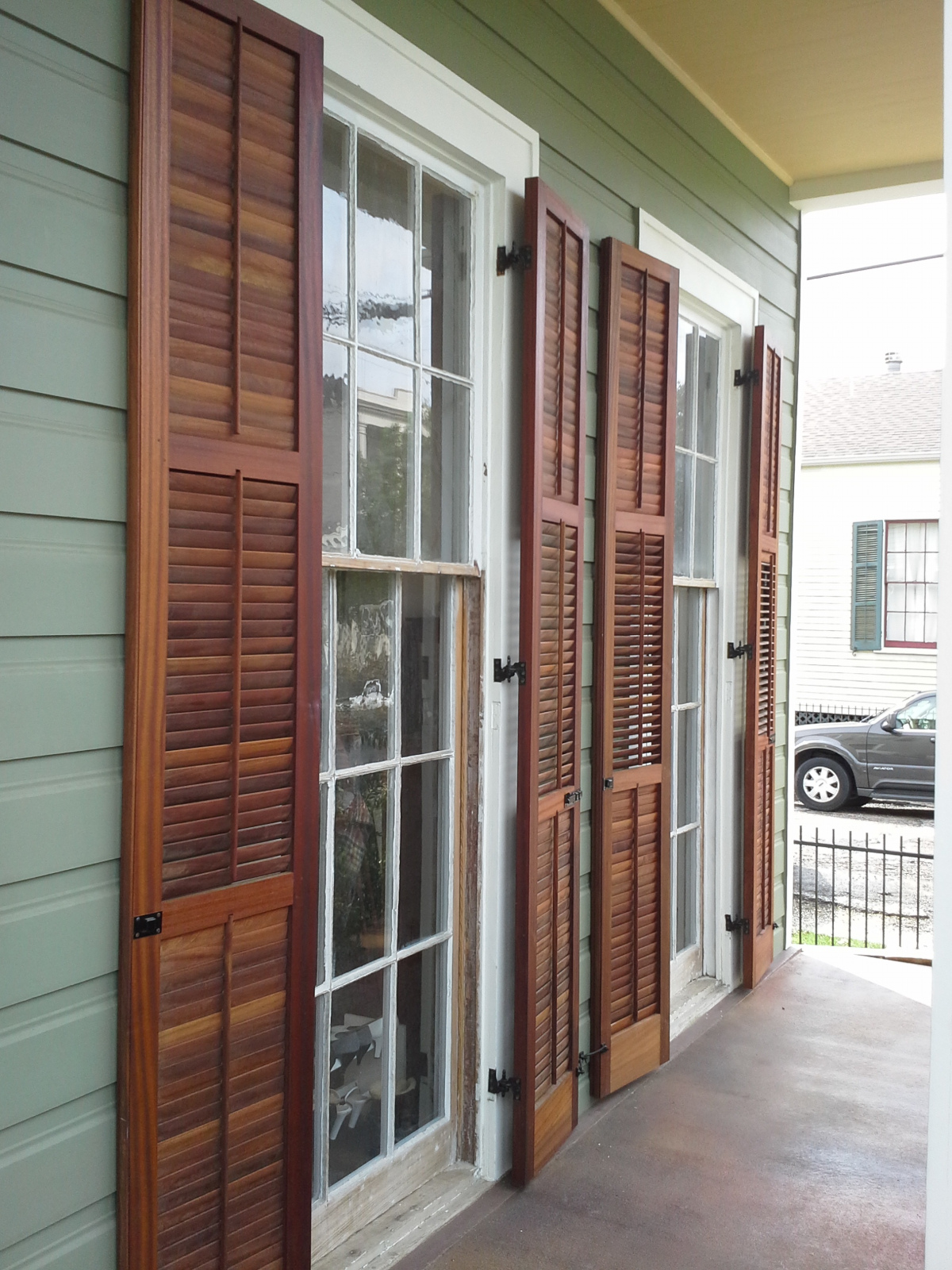 operable louvered shutters on a covered porch