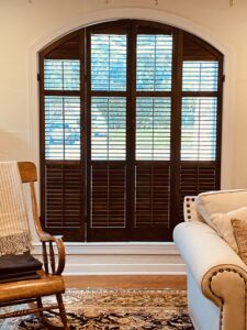 Interior arched shutters with operable louvers