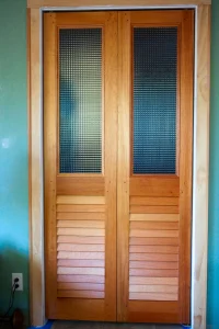 Custom bifold doors with cross reeded sheet over fixed louvers